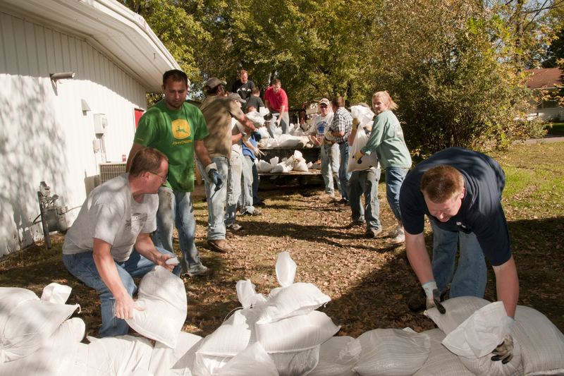Volunteers assisting with flood cleanup inside a property
